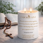 Load image into Gallery viewer, Tabor Olive candle with Philippians 4:6-8 Bible Verse, wooden rosary, and open bible on a light surface.
