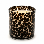 Load image into Gallery viewer, A two-wick scented candle in a cylindrical glass vessel with a glossy black and cream spotted pattern, lit with two visible flames against a plain white background.
