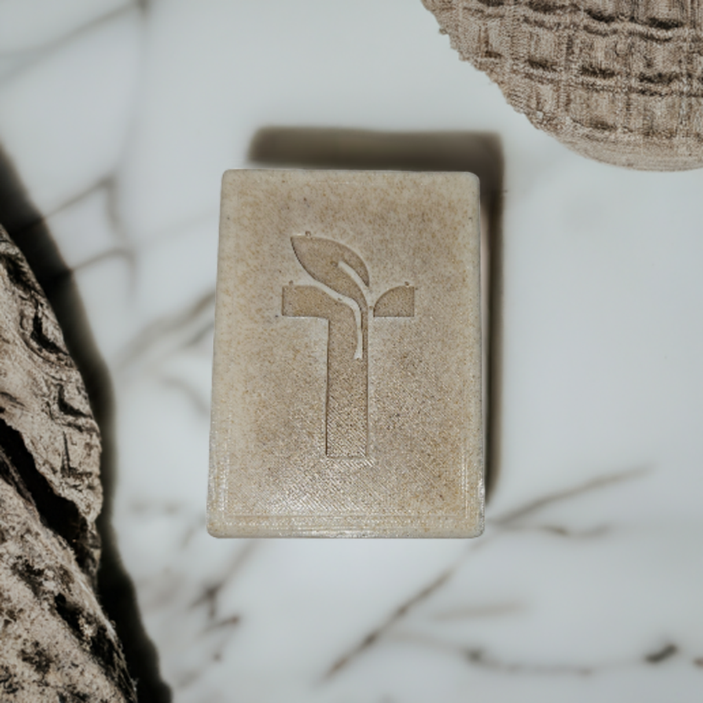 Bar Soap laying on marble platform next to a towel
