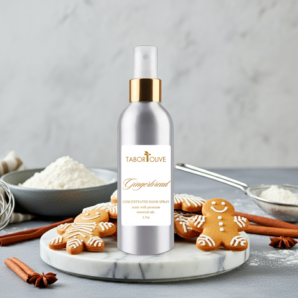 Tabor Olive Gingerbread concentrated room spray on a marble tray with gingerbread cookies and cinnamon sticks.