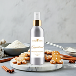 Load image into Gallery viewer, Tabor Olive Gingerbread concentrated room spray on a marble tray with gingerbread cookies and cinnamon sticks.
