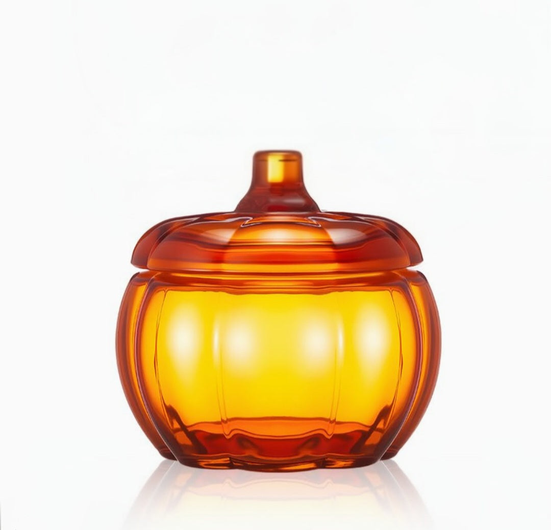 Amber glass pumpkin-shaped container on a white background