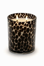 Load image into Gallery viewer, Black spotted candle jar showing 2 lit wicks on a white background. 
