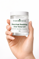 Load image into Gallery viewer, Hand holding a jar of Tabor Olive Premium Soothing Aloe Vera Gel against a white background
