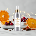 Load image into Gallery viewer, Bottle of Tabor Olive room spray surrounded by oranges, cranberries, and cinnamon sticks on a light background
