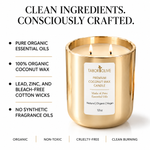 Load image into Gallery viewer, A gold Tabor Olive Premium Coconut Wax Candle with two lit wicks and visible flames. The image includes marketing text on a white background highlighting pure organic essential oils, 100% organic coconut wax, lead-free cotton wicks, and no synthetic fragrance oils.
