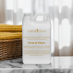 Load image into Gallery viewer, White detergent jug sitting on marble platform next to wooven basket with rust colorwd towels and gold text that says, &quot;free and clear premium laundry detergent all natural hypoallergenic pH balanced non-toxic biobased preferred&quot;
